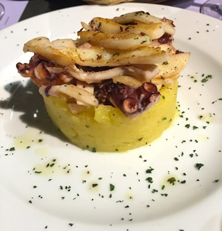 seared octopus and squid slivers on top on smashed potatoes